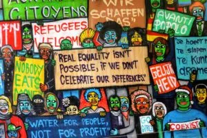 An image of cartoon characters holding various placards relating to the issue of equality to illustrate post