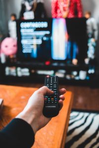 Image of a person using a remote control to watch TV, used to illustrate post