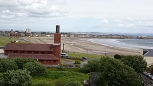 Image of a photograph, taken from the Cannon Hill in Ardrossan of the town's Catholic church, and the sea in the background to illustrate the post