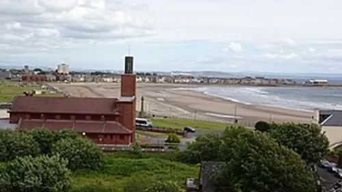 Image of a photograph, taken from the Cannon Hill in Ardrossan of the town's Catholic church, and the sea in the background to illustrate the post