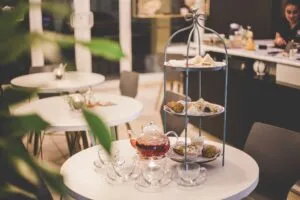 Image of a table laid-out with a tower of sandwiches and cakes for 'afternoon tea' to illustrate post